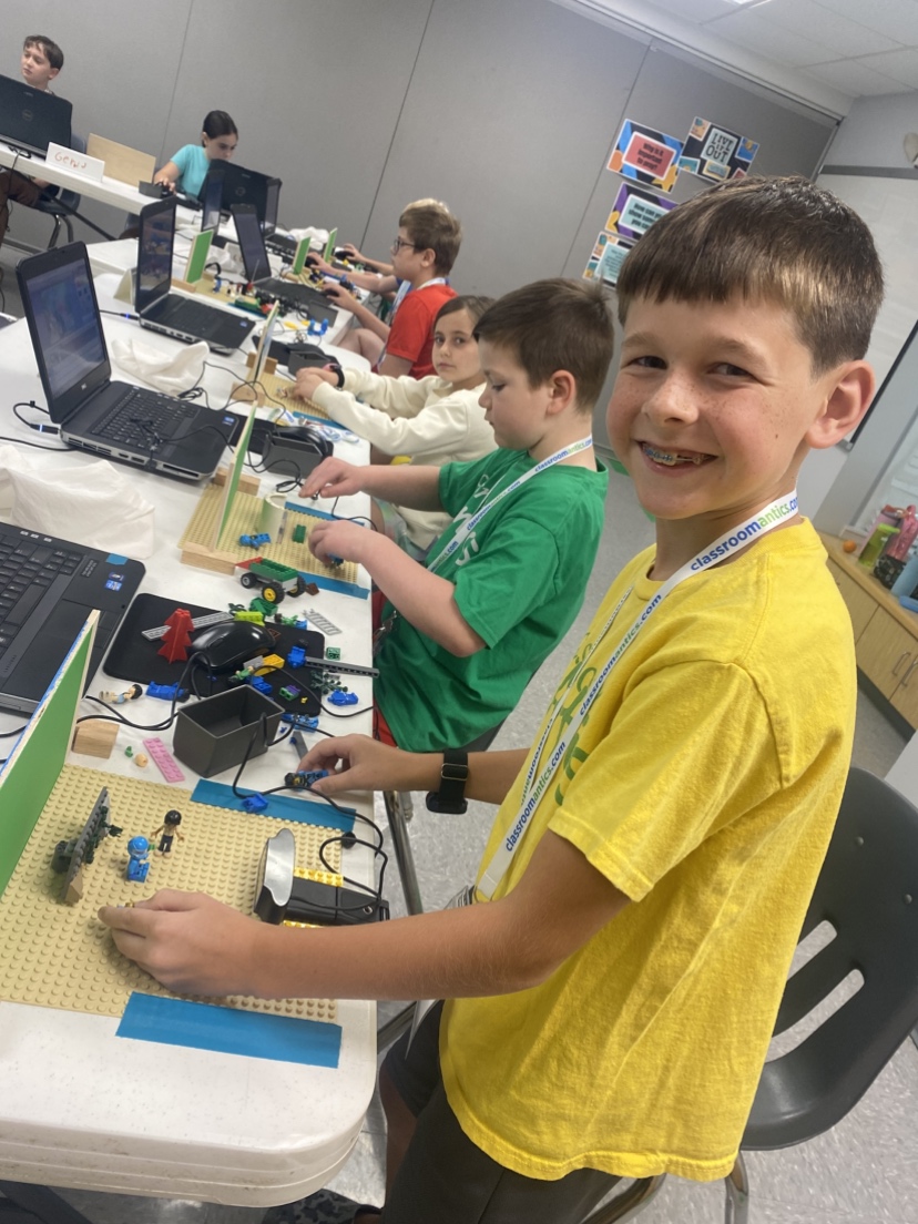 Kids using Scratch or doing stop motion animation at Classroom Antics summer camp.